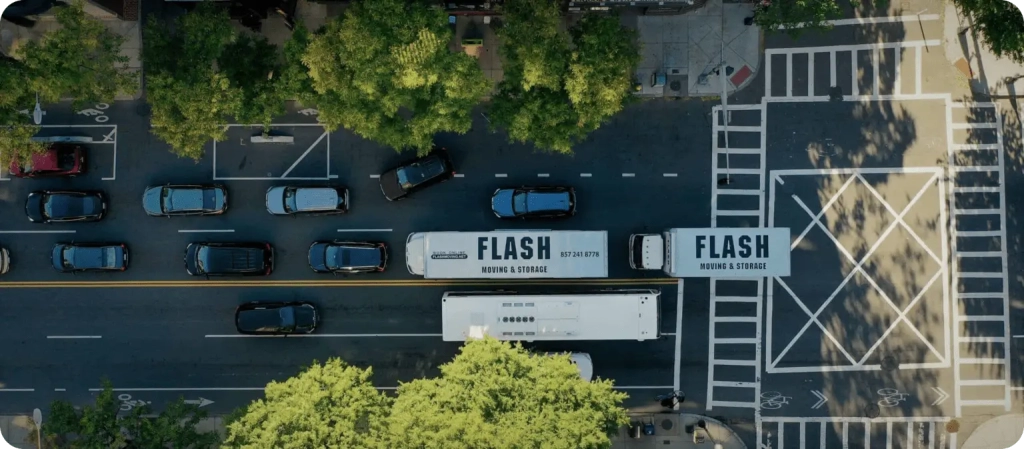 Two Moving Truck driving across Boston to Move Students from University to Storage