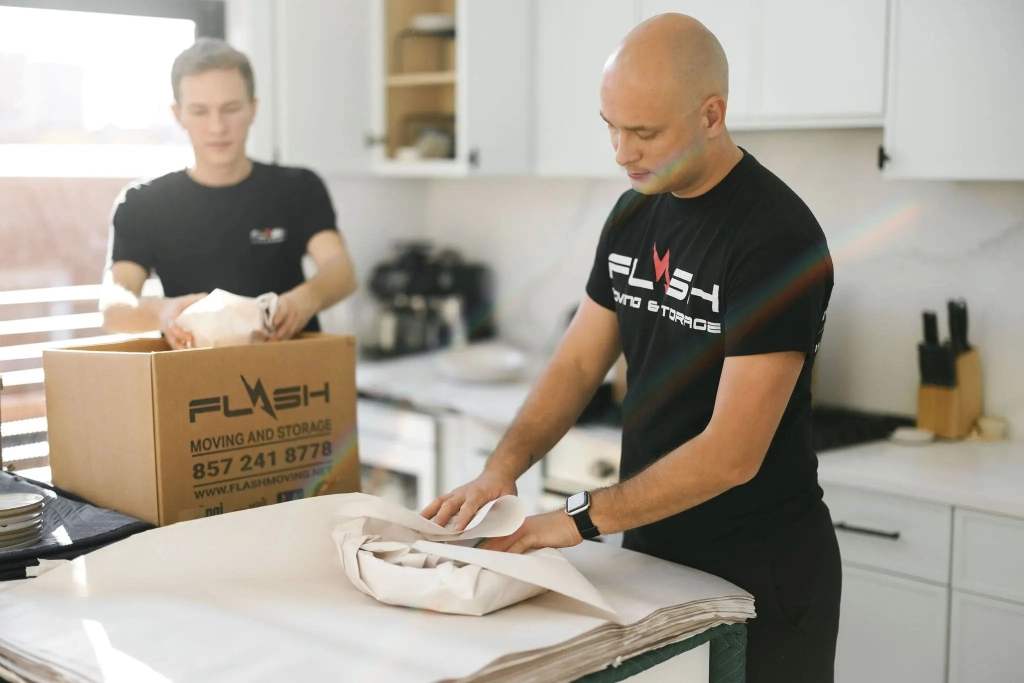 Professional movers packing kitchen items for emergency move out service – Flash Moving & Storage