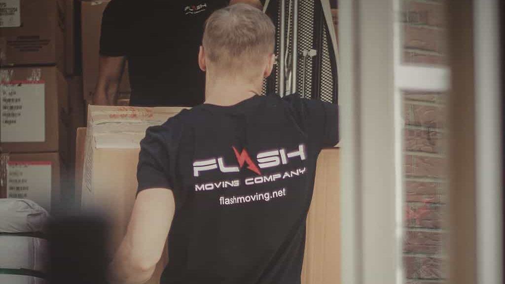 Flash Moving Company worker carrying boxes during a professional college student move in Boston. Reliable and efficient movers specializing in dorm and apartment relocations